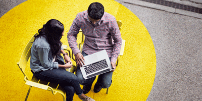 Two people with laptop